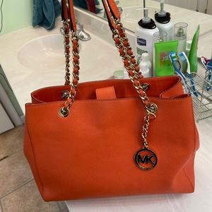 Michael Kors Orange leather medium size bag.